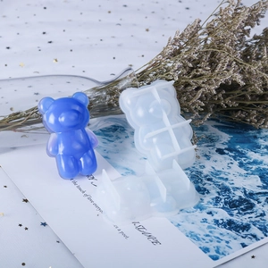 Macro shot of bear-shaped silicone mold with semi-transparent blue resin craft piece