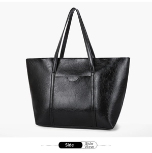 Close-up side view of a black large-capacity tote bag in glossy oil wax faux leather