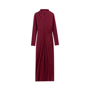 Detailed view of the elegant side ruching and burgundy fabric texture on the midi dress