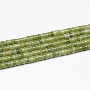 Macro detail of four strands of green natural stone cylinder beads for DIY jewelry making