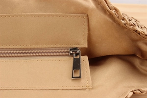 Detail view of khaki woven bag interior with cotton lining and premium metal zipper