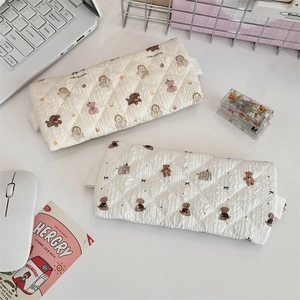 Close-up of quilted floral lace pencil pouches with cute bear and dog cartoon patterns