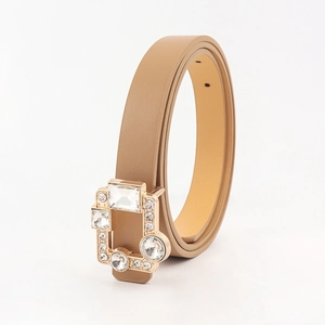 Close-up of camel leather thin belt featuring a gold buckle with sparkling crystal inlays