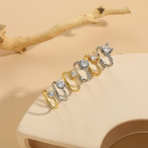 Detailed view of six-piece luxury zircon rings set in gold and silver plating on wood
