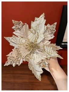 Detailed close-up of champagne gold glitter Christmas flower with intricate sequin texture
