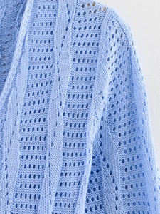 Gros plan d'une robe longue en maille ajourée bleu clair avec texture délicate