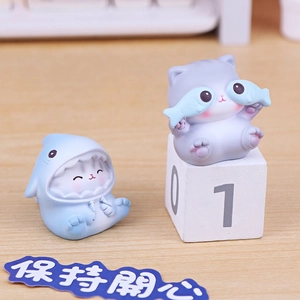 Cute pudding cat resin figurines featuring shark outfit and fish for office desk decor