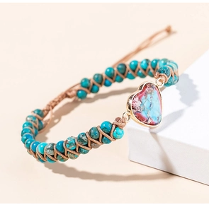 Detail of adjustable woven boho bracelet with blue stone beads and heart-shaped charm