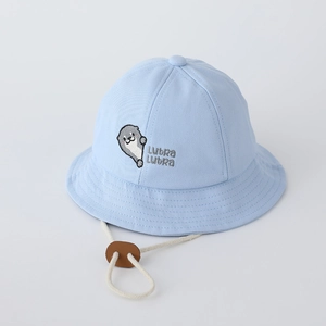 Detail of light blue baby bucket hat featuring otter embroidery and woven windproof rope