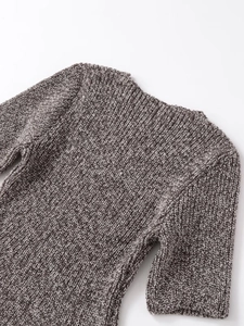 Close-up of marled grey and brown knit texture and crew neckline of the short sleeve top