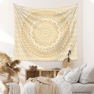 Detail of bohemian mandala tapestry featuring golden geometric patterns on soft fabric