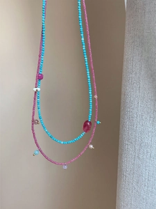 Detail of turquoise and rose pink natural stone beaded necklaces for women