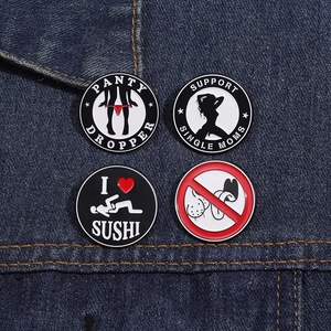Macro shot of funny round enamel pins with various English slogans on denim fabric