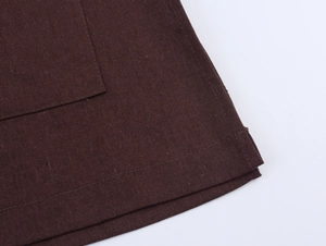 Detail shot of chestnut brown blazer showing durable cotton-linen texture and double stitching