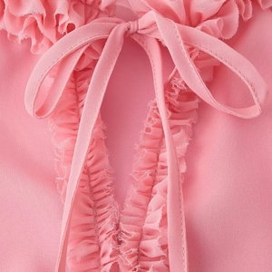 Pink bohemian chiffon blouse with tiered ruffles, V-neckline, and bow tie detail