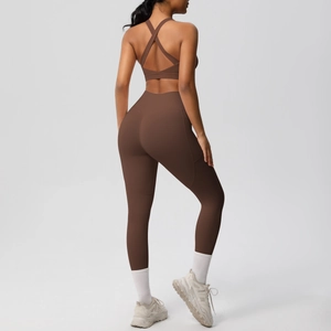 Detail of cross-back sports bra and high-waisted yoga leggings with side pockets