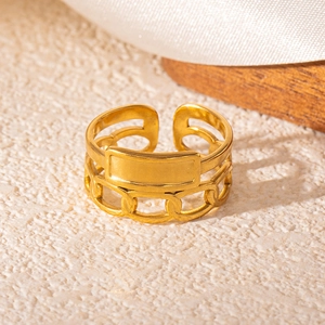 Macro view of gold snake style ring with chain texture and minimalist rectangular plate