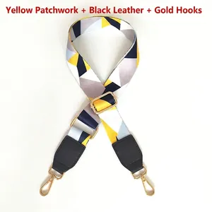 Detail of colorful geometric wide shoulder strap with black leather and gold metal hooks