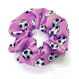 Detail of purple satin soccer scrunchie showing smooth fabric texture and elastic band