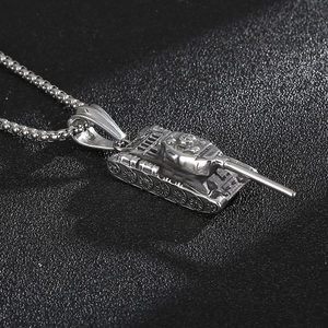 Detailed close-up of a silver stainless steel tank pendant with a 3D textured design