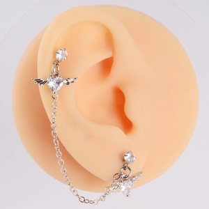 Detail of silver angel wing heart ear cuff with zircon heart and long link chain
