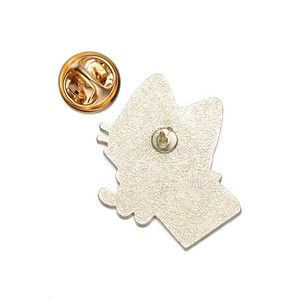 Detailed back view of gold cartoon cat metal badge with butterfly clasp fastener