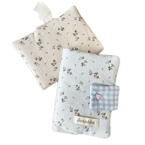 Floral fabric notebook covers in light blue and beige with heart buckle and check ribbon