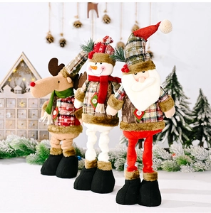Close-up of telescopic Christmas dolls with reindeer, snowman and Santa in plaid outfits
