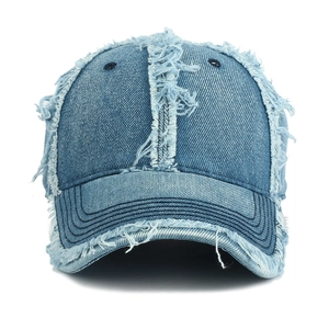 Distressed light blue denim baseball cap with vintage frayed edges and fringe details