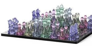 Macro shot of colorful resin chess pieces showing transparency and light reflection on board