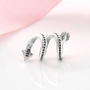 Macro shot of S925 sterling silver arrow charm with vintage texture and S925 hallmark