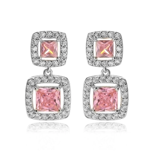 Detail view of silver earrings with princess cut pink zircons in a square halo design