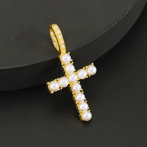 Golden cross pendant necklace with inlaid white pearls on a Cuban tennis chain