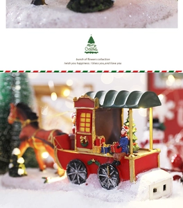 Detail of LED Christmas carriage with Merry Christmas sign on a snowy base