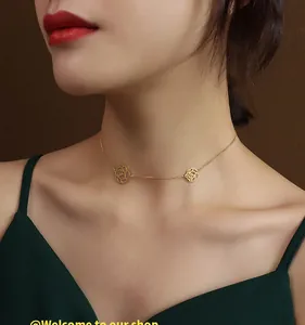 Detail view of 18K gold plated titanium necklace with delicate hollow rose pendants