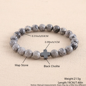 Detailed close-up showing map stone beads and black hematite cross on this stone bracelet