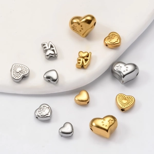 Macro shot of gold and silver Baroque LOVE heart beads for DIY jewelry making