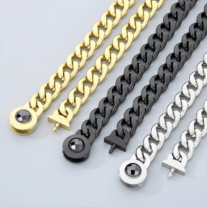 Detail of 13mm Cuban link chains in gold, black, and silver with black gemstone clasp