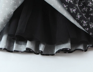 Detail of floral printed fabric with black tulle mesh lining for a layered dress