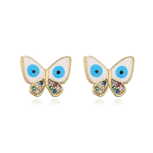 Macro detail of 18K gold plated butterfly studs with evil eye enamel and colorful zircons