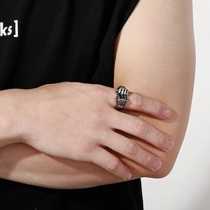 Detail of vintage silver double fist ring showing metallic texture on male model