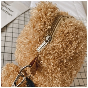 Detailed macro view of the brown plush bag featuring a sturdy metal zipper and lobster clasp