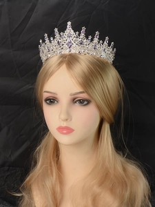 Detail of silver crown headpiece with purple and clear rhinestones on a model