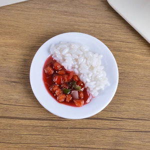 Macro view of realistic PVC miniature rice bowl with glazed meat topping on white plate