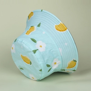 Close-up of light blue sun hat featuring yellow mango and white daisy floral patterns