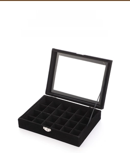 Macro detail of a 24-grid black velvet jewelry box with transparent glass lid and metal clasp