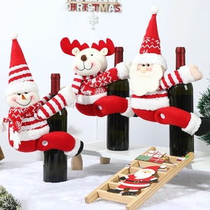 Knitted Christmas wine bottle covers featuring Santa, reindeer, and snowman designs