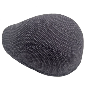 Detail of dark grey tweed winter flat cap showing premium woven fabric and reinforced stitching