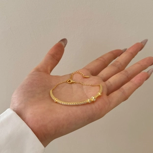 Detailed view of a gold S925 sterling silver bracelet with sparkling zircon stones