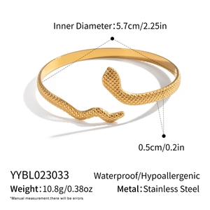 Macro detail of golden snake-shaped stainless steel bracelet showing waterproof texture